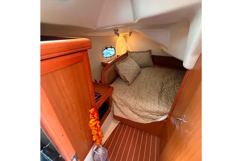 Slide: The Image of Cozy cabin interior of 2008 Hunter 36 sailboat with wood finish and comfortable bedding. - 32