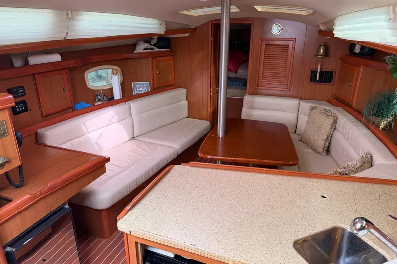 Slide: The Image of Interior of a 2008 Hunter 36 sailboat with cozy seating and wooden finishes. - 33