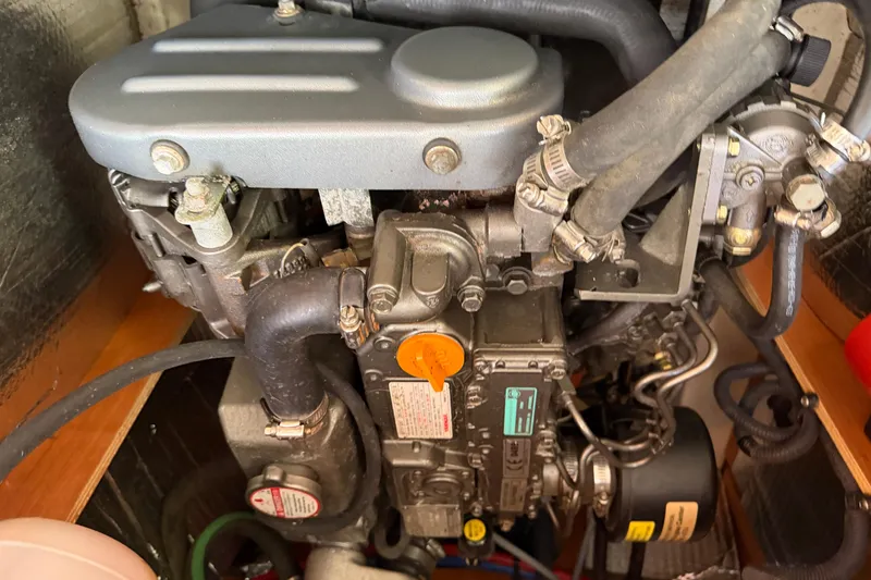 Slide: The Image of Engine compartment of a 2008 Hunter 36 sailboat, showcasing mechanical components and hoses. - 36