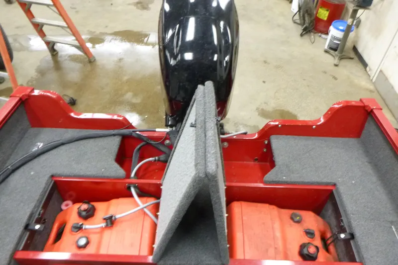 Slide: The Image of 2022 Lund 1650 Angler Sport boat interior with fuel tanks and motor. - 12