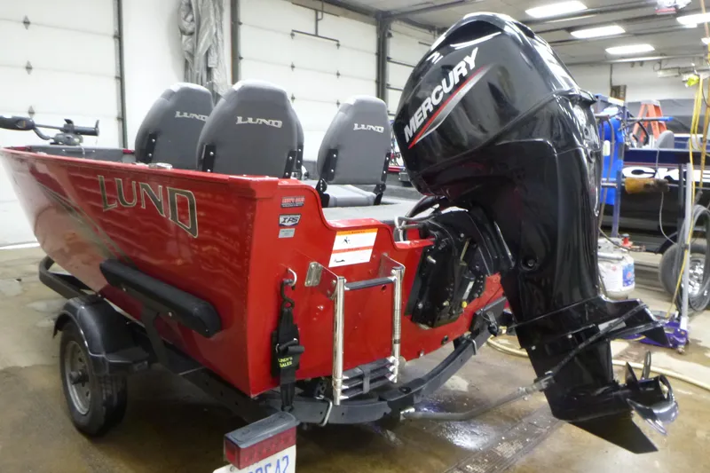 Slide: The Image of 2022 Lund 1650 Angler Sport boat with Mercury outboard motor in a garage. - 3