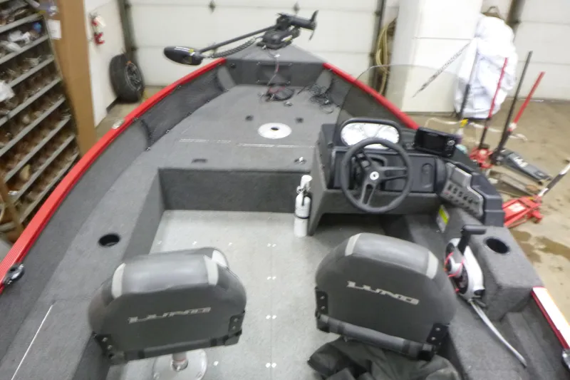 Slide: The Image of 2022 Lund 1650 Angler Sport boat interior with steering console and seating. - 6