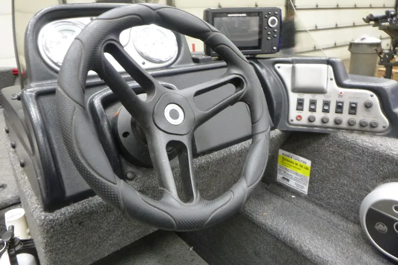 Slide: The Image of Steering console of 2022 Lund 1650 Angler Sport boat with gauges and controls. - 7