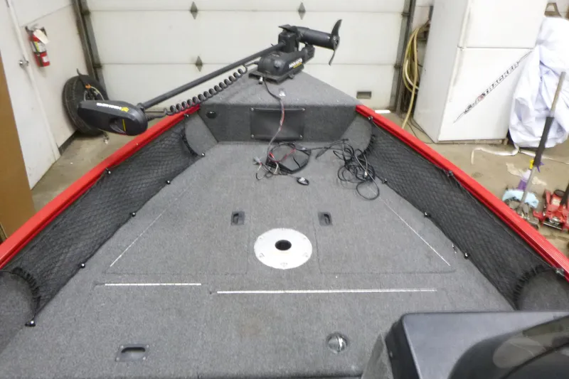 Slide: The Image of 2022 Lund 1650 Angler Sport boat interior with trolling motor in garage. - 8