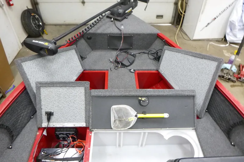 Slide: The Image of 2022 Lund 1650 Angler Sport boat interior with storage compartments open. - 9