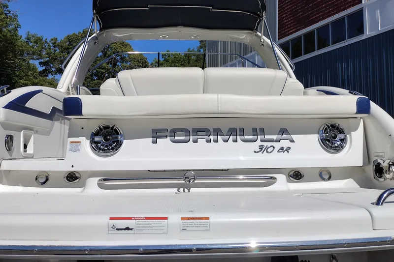 Slide: The Image of 2022 Formula 310 Bowrider boat rear view with logo and seating. - 11