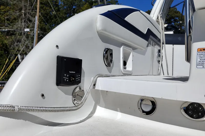 Slide: The Image of 2022 Formula 310 Bowrider boat deck with control panel and sleek design elements. - 13