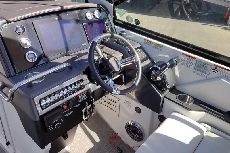 Slide: The Image of 2022 Formula 310 Bowrider helm with modern controls and navigation displays. - 17