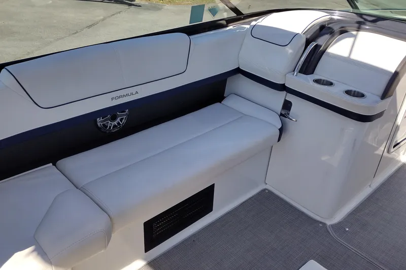 Slide: The Image of 2022 Formula 310 Bowrider interior with white seating and cup holders. - 18
