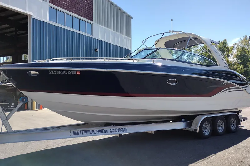 Slide: The Image of 2022 Formula 310 Bowrider boat on trailer outside a building. - 2