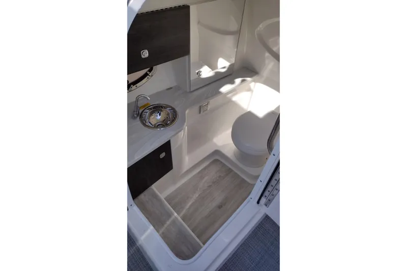 Slide: The Image of 2022 Formula 310 Bowrider interior bathroom with sink and toilet. - 24