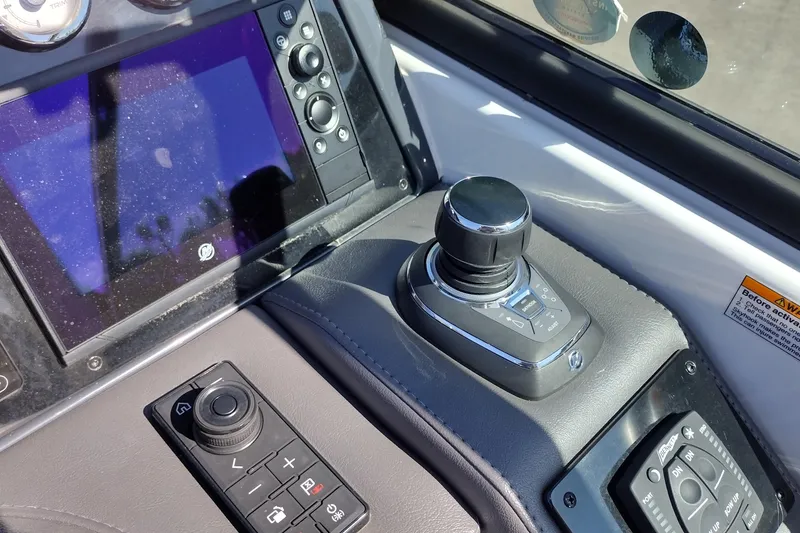 Slide: The Image of 2022 Formula 310 Bowrider dashboard with joystick control and navigation display. - 29