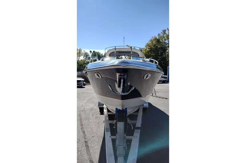 Slide: The Image of 2022 Formula 310 Bowrider boat on trailer, parked outdoors under clear sky. - 3