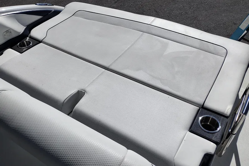 Slide: The Image of 2022 Formula 310 Bowrider boat seating area with cup holders, featuring white upholstery. - 32