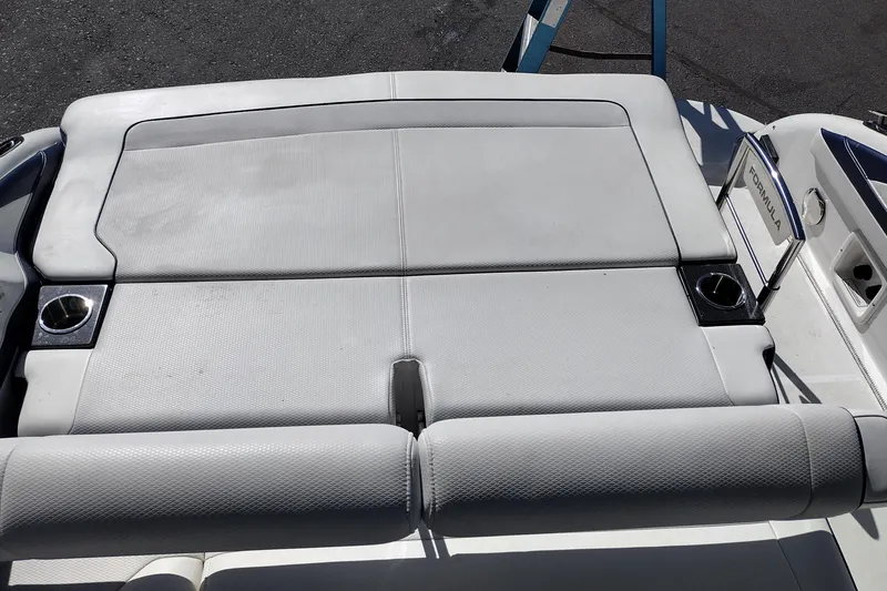 Slide: The Image of 2022 Formula 310 Bowrider boat with cushioned seating and cup holders. - 33