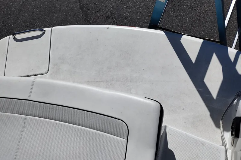 Slide: The Image of 2022 Formula 310 Bowrider boat deck with white upholstery and metal railing. - 37