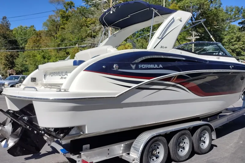 Slide: The Image of 2022 Formula 310 Bowrider boat on trailer, featuring sleek design and modern aesthetics. - 5