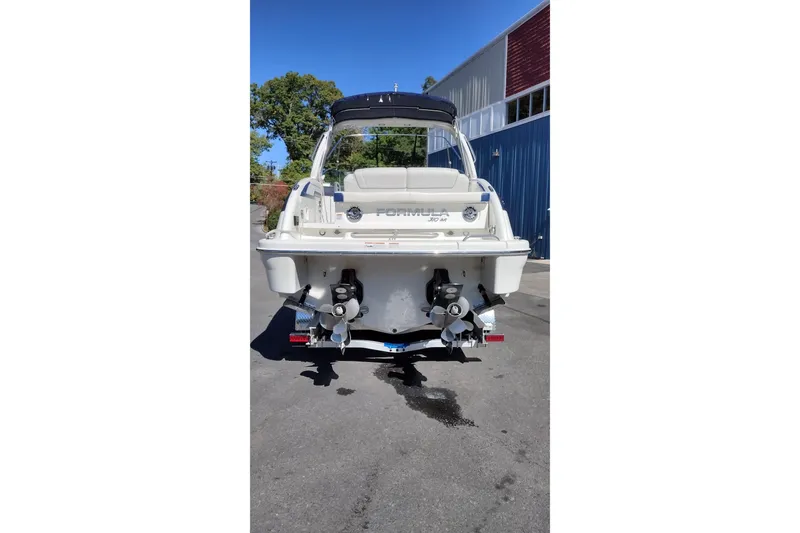 Slide: The Image of 2022 Formula 310 Bowrider boat, rear view, parked outdoors on a sunny day. - 6