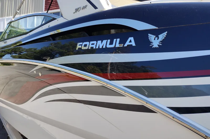 Slide: The Image of 2022 Formula 310 Bowrider boat with sleek design and vibrant graphics. - 8