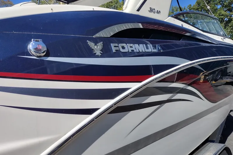 Slide: The Image of 2022 Formula 310 Bowrider boat with sleek design and vibrant graphics. - 9