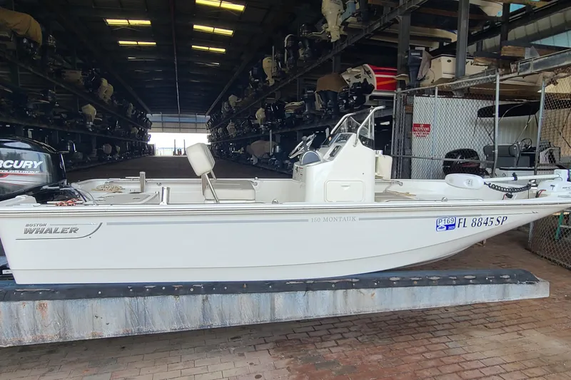The Image of 2019 Boston Whaler 150 Montauk boat stored indoors, side view. - 0