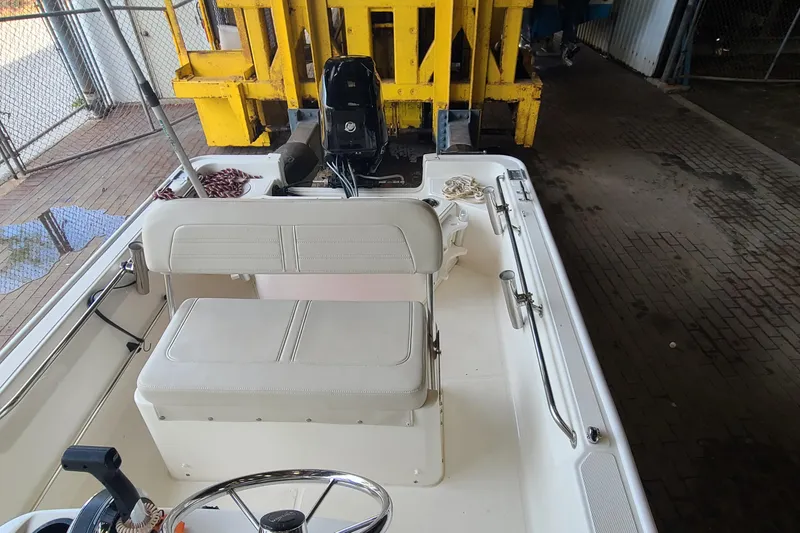 Slide: The Image of 2019 Boston Whaler 150 Montauk boat interior with steering wheel and seating. - 15