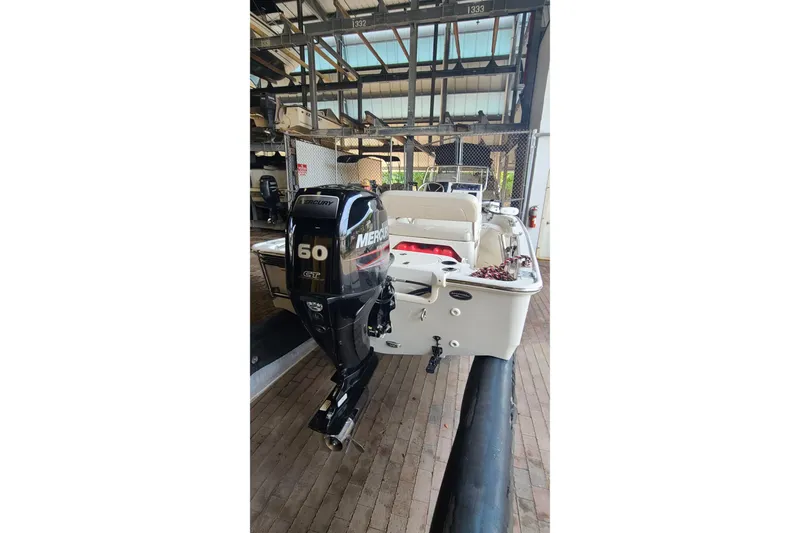 Slide: The Image of 2019 Boston Whaler 150 Montauk with Mercury 60 HP engine in storage facility. - 17