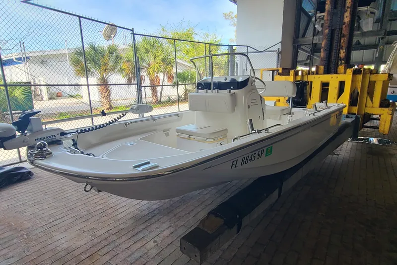 Slide: The Image of 2019 Boston Whaler 150 Montauk boat in storage, featuring Minn Kota trolling motor. - 2