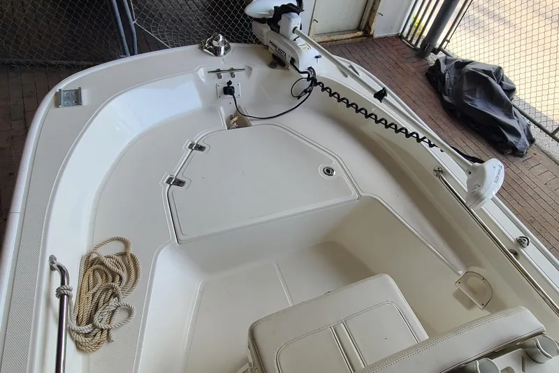 Slide: The Image of 2019 Boston Whaler 150 Montauk boat interior with rope and trolling motor. - 4