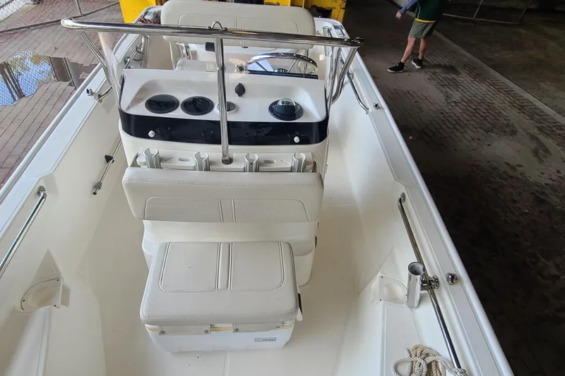 Slide: The Image of 2019 Boston Whaler 150 Montauk boat interior with seating and console. - 8