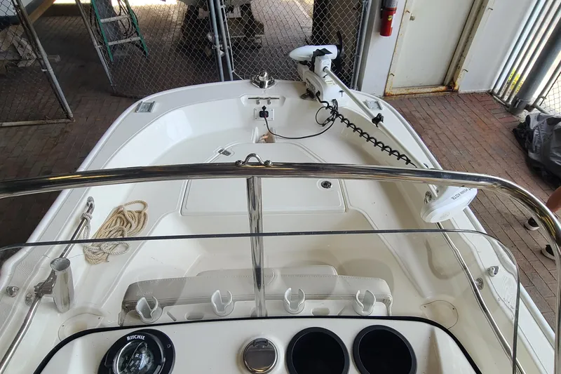 Slide: The Image of 2019 Boston Whaler 150 Montauk boat interior with steering console and trolling motor. - 9