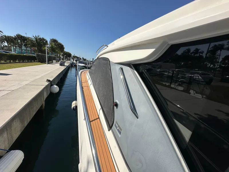 Slide: The Image of 2018 Bavaria S40 Coupe docked at marina, sunny day, palm trees in background. - 22