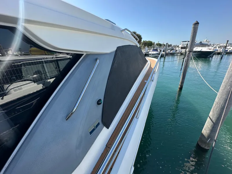 Slide: The Image of 2018 Bavaria S40 Coupe yacht docked at marina, side view with clear blue water. - 23