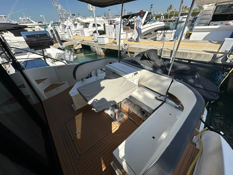 Slide: The Image of 2018 Bavaria S40 Coupe yacht deck with seating and table at marina. - 26