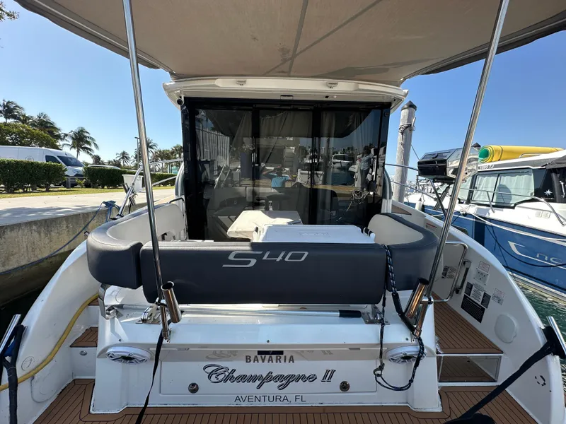 Slide: The Image of 2018 Bavaria S40 Coupe yacht docked, rear view with seating and canopy. - 28
