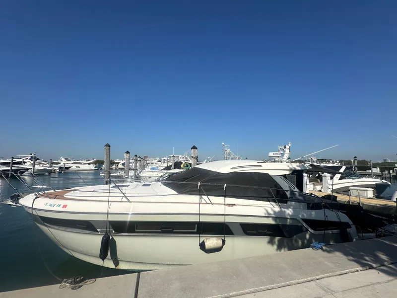 Slide: The Image of 2018 Bavaria S40 Coupe yacht docked at a marina under clear blue skies. - 3