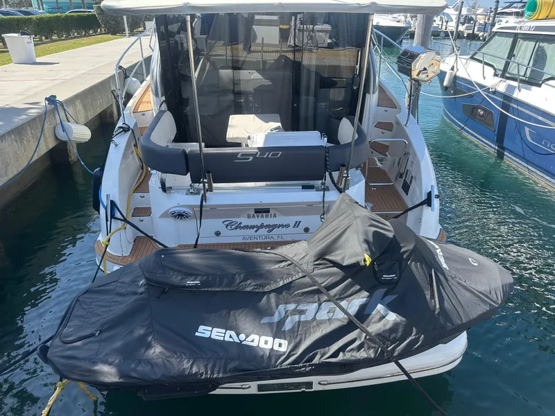 Slide: The Image of 2018 Bavaria S40 Coupe yacht with Sea-Doo jet ski, docked in a marina. - 30