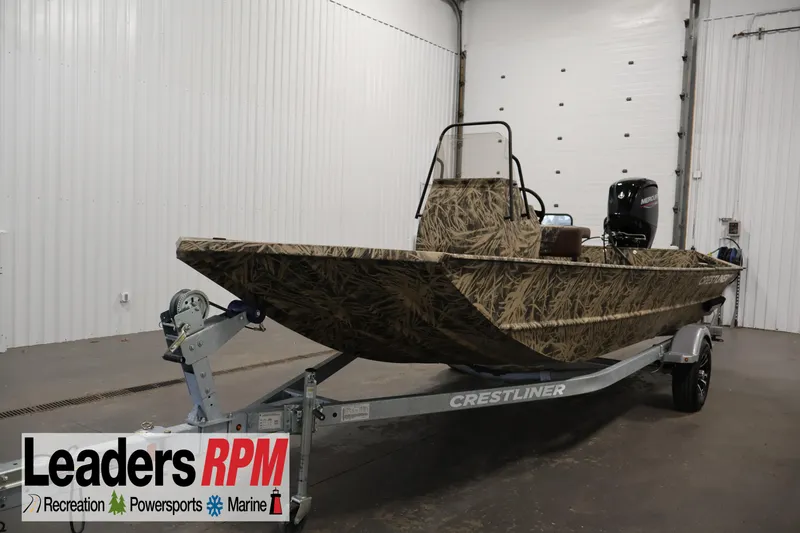 The Image of 2024 Crestliner 1870 Retriever FCC boat with camouflage design on trailer in indoor setting. - 1