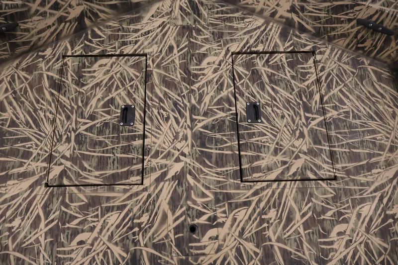 Slide: The Image of 2024 Crestliner 1870 Retriever FCC boat with camouflage pattern and dual storage compartments. - 12