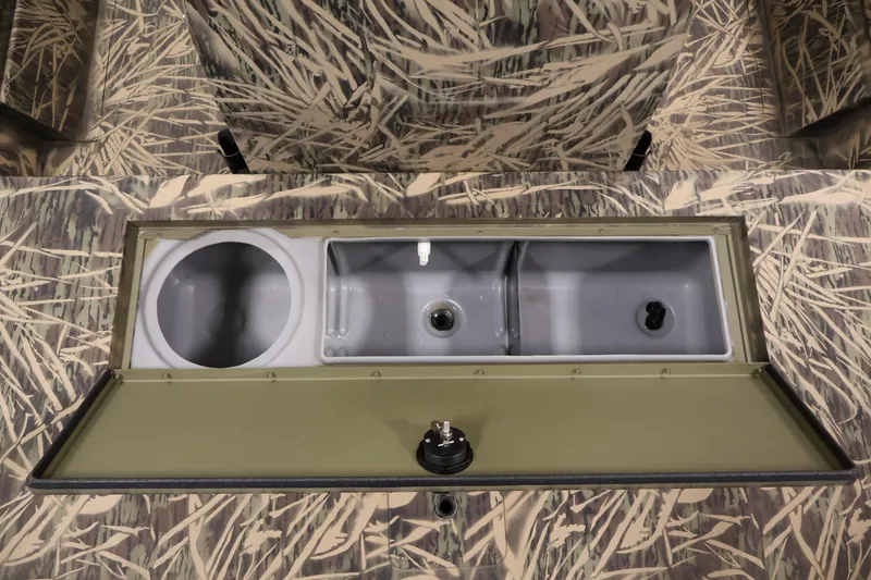 Slide: The Image of 2024 Crestliner 1870 Retriever FCC boat interior with camouflage design and storage compartments. - 14