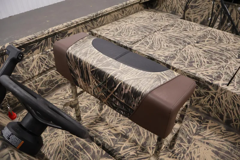 Slide: The Image of 2024 Crestliner 1870 Retriever FCC boat interior with camouflage seating and steering wheel. - 22