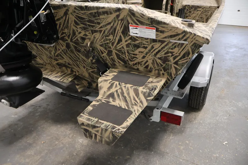 Slide: The Image of 2024 Crestliner 1870 Retriever FCC boat with camouflage design on a trailer. - 26