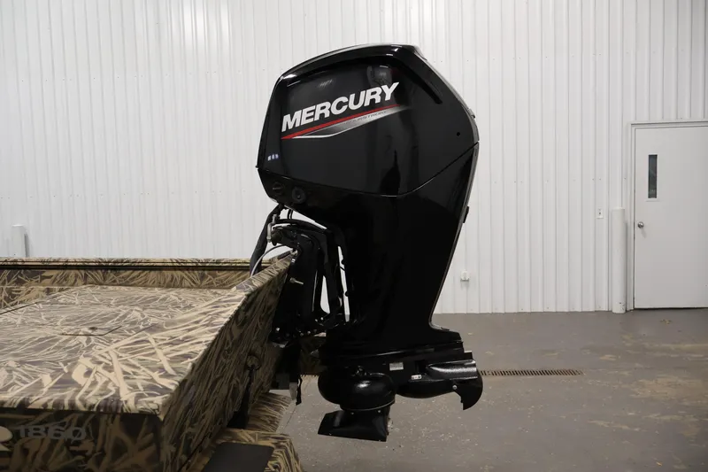 Slide: The Image of 2024 Crestliner 1870 Retriever FCC with Mercury outboard motor in a garage. - 28