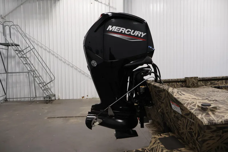 Slide: The Image of 2024 Crestliner 1870 Retriever FCC with Mercury outboard motor in a garage setting. - 29