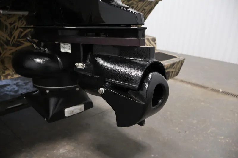 Slide: The Image of 2024 Crestliner 1870 Retriever FCC boat motor detail in a garage setting. - 31