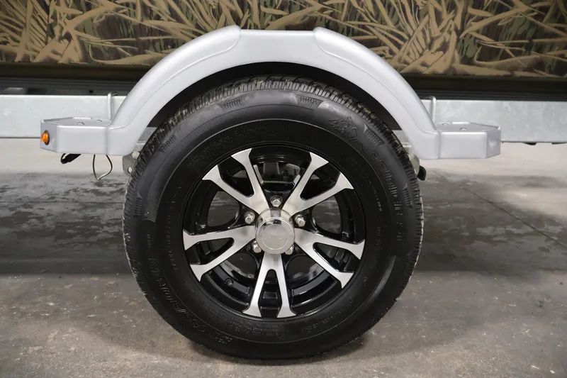 Slide: The Image of 2024 Crestliner 1870 Retriever FCC trailer wheel with sleek black and silver alloy rim. - 34