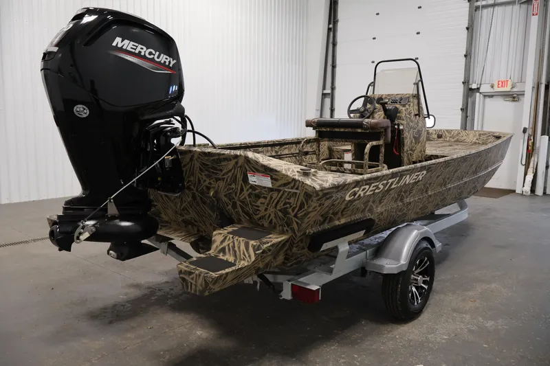 Slide: The Image of 2024 Crestliner 1870 Retriever FCC boat with Mercury engine in a garage setting. - 5