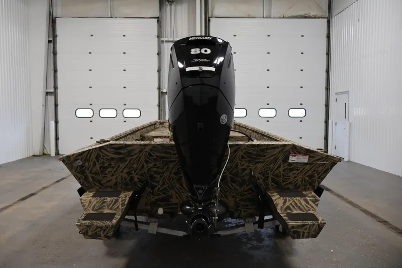 Slide: The Image of 2024 Crestliner 1870 Retriever FCC boat with camouflage design in a garage. - 6