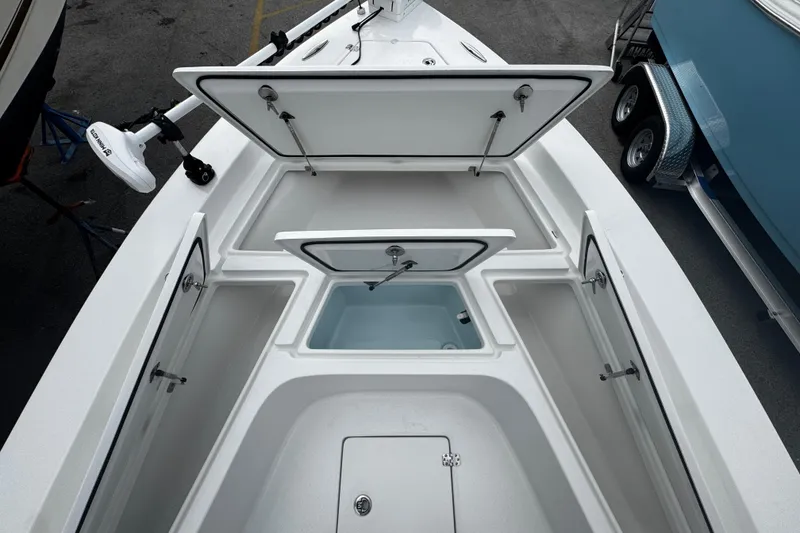 Slide: The Image of Open storage compartments on a 2026 Piranha Casador B2200 boat deck. - 11