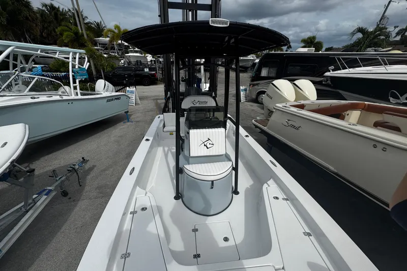 Slide: The Image of 2026 Piranha Casador B2200 boat displayed at a marina, surrounded by other vessels. - 12